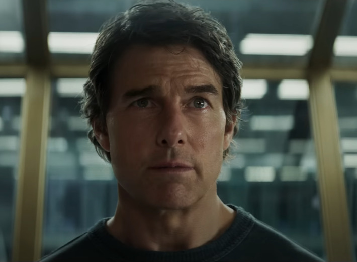 Tom Cruise as Ethan Hunt, intensely looking into the distance, capturing the tension and focus of a high-stakes Mission Impossible moment